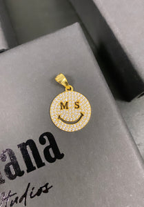 Gold MS smiley pendant.